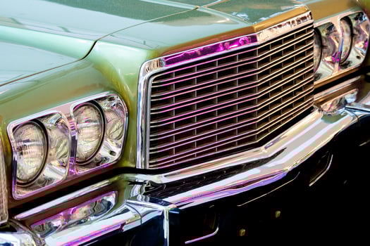 Exhibition of retro cars. Fragment of the front part of the car with round headlights and grille photo