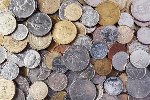 Flat lay view of a coins of different countries of the world as background, texture photo