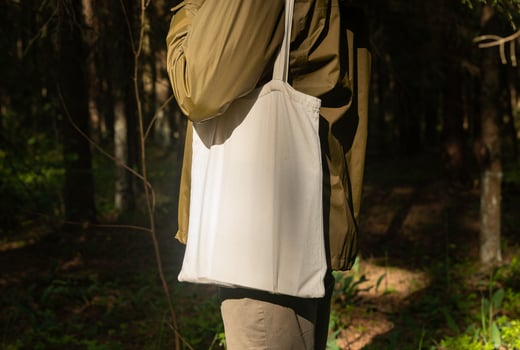 . Canvas tote bag on male shoulder, nature forest background photo