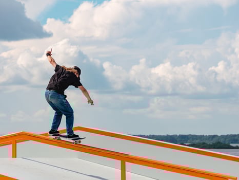 Young man doing jump trick on skateboard photo