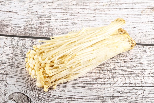 Tasty raw enoki mushroom heap photo