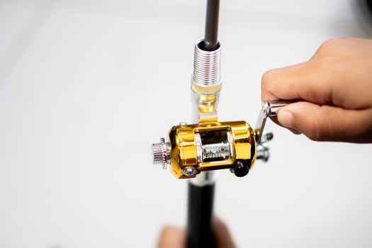 Adjusting a fishing reel on a rod photo