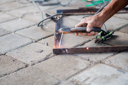 Close-up of welding metal rods on a paved surface photo