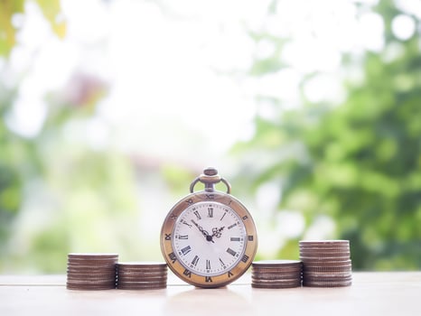 Vintage watch and stack of coins. The concept of saving money for manage time to success business. photo