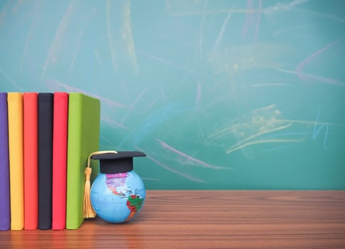 Student creative desktop , earth globe with graduation hat and hardcover book. Copy space for text, Back to school, Education concept photo