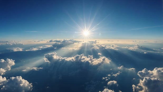 Breathtaking panoramic image of a vivid blue sky filled with radiant sunlight and fluffy white clouds, evoking a sense of serenity and expansive beauty. photo