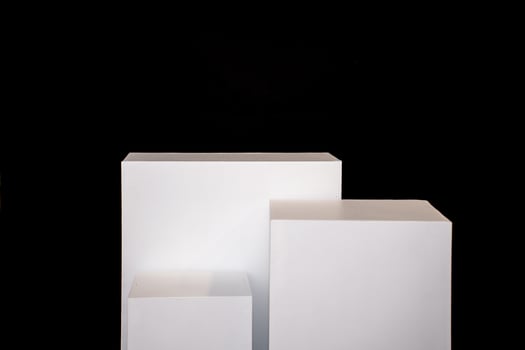Product photography mockup. White bases against black background. photo