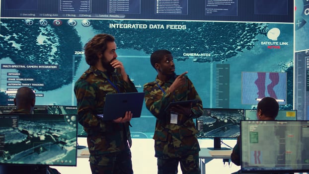 Diverse team of infantry unit leader and commander gather intelligence via radar surveillance, examine a world map to ensure national safety. Officers operating in mission control center. Camera B. photo