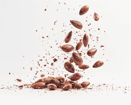 Chocolate Nuts Falling on White Background photo