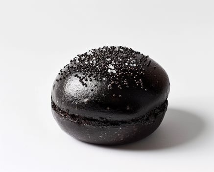 A Black Macaroon with Sprinkles on Top photo