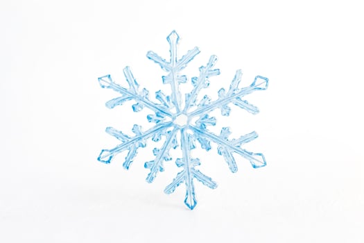 Delicate Blue Snowflake on White Background photo