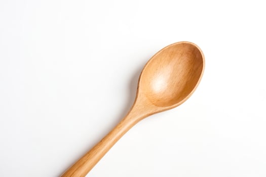 Wooden spoon isolated on white background photo