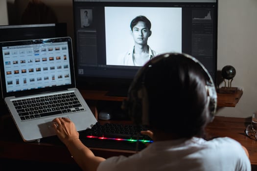 Woman with headphones working on photo editing