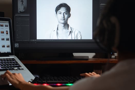 Woman with headphones working on photo editing