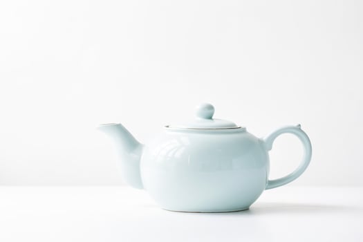 White Teapot with Black Stripe on White Background photo