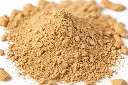 Crushed Ginger Powder on White Background photo