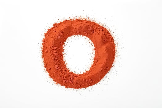 Orange powder forming the letter O on a white background photo