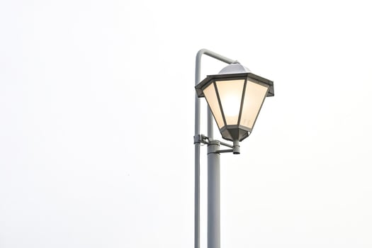Street lamp against white sky photo