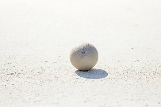 Single stone ball on white ground photo