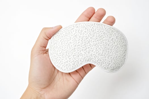 White Eye Mask with Lace Pattern Held in Hand photo
