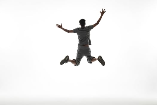 Silhouette of a man jumping in the air photo