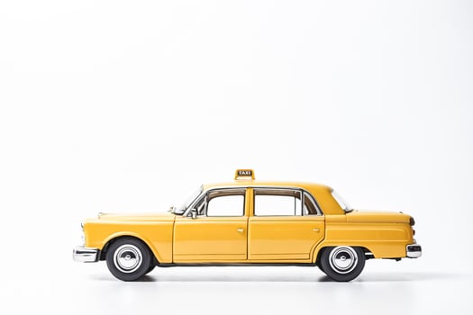 Yellow Taxi Cab Toy on White Background photo