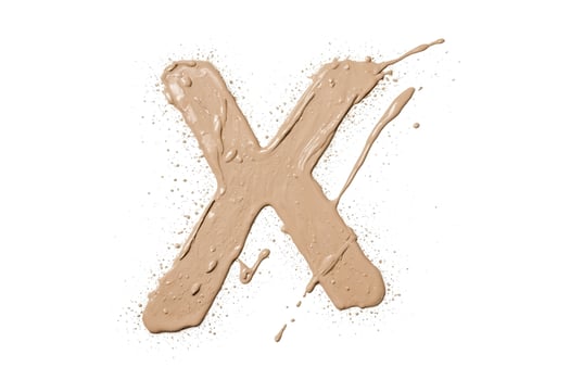 Splashes of Beige Makeup Forming the Letter X photo
