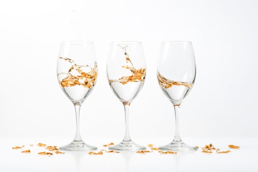 Three Wine Glasses with Gold Petals on White Background photo