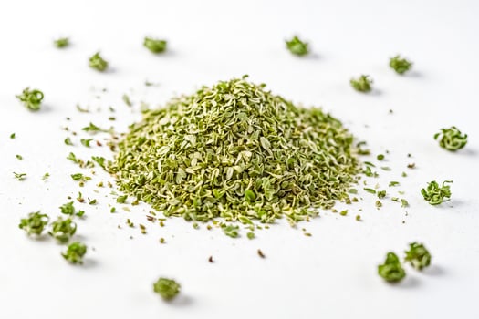 Dried oregano leaves on white background photo