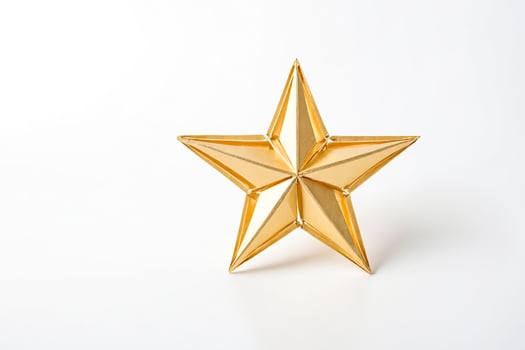 Golden Origami Star on White Background photo