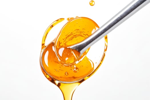 Honey Dripping from a Spoon photo