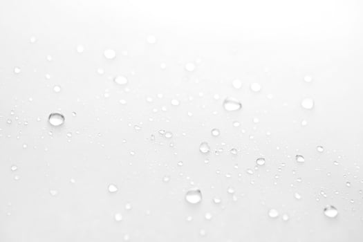 Close Up of Water Droplets on White Surface photo