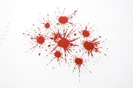 Red paint splatters on white background photo