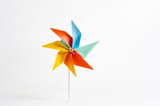 Colorful Paper Pinwheel on White Background photo