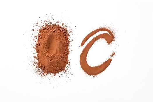 Cocoa powder letters on white background photo
