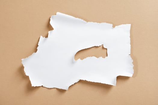 Ripped white paper on brown background photo