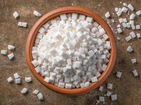 White sugar cubes in a terracotta bowl photo