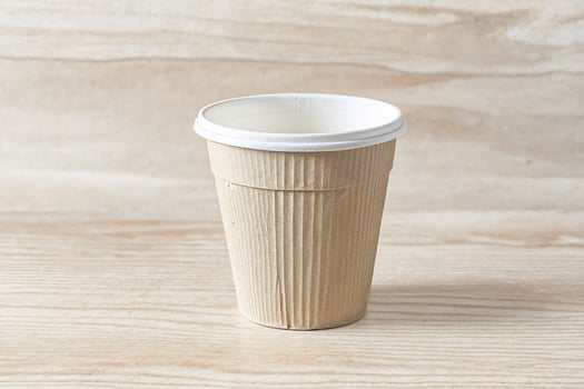 Empty Paper Coffee Cup on Wooden Background photo