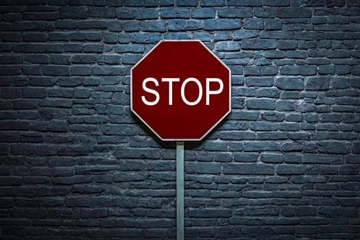 Stop Sign Against a Brick Wall photo