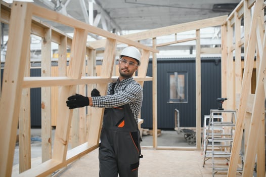 Worker carpenter assembling a modular house photo