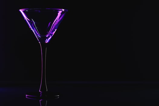 silhouette of martini glass on black background photo