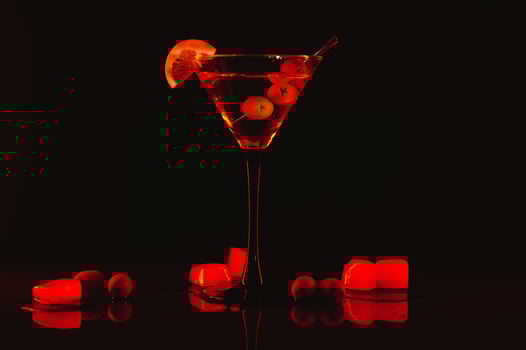 Martini glass and olives on a black background with neon lights photo