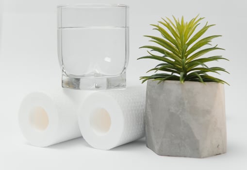 A glass of drink water and filter cartridges at white background photo