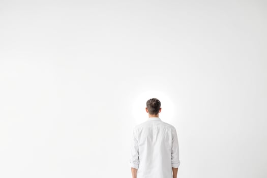 Man in White Shirt Standing in Front of a White Wall photo