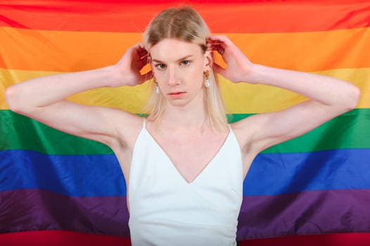 Young transgender woman on red background. photo