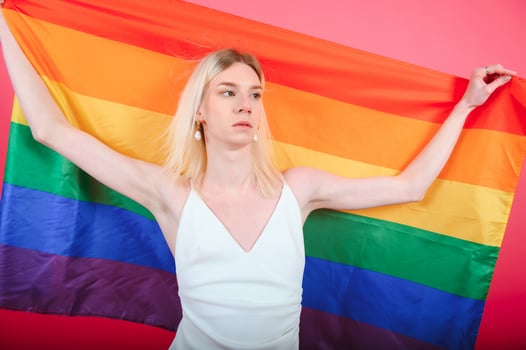 Portrait of young transgender woman on color background photo