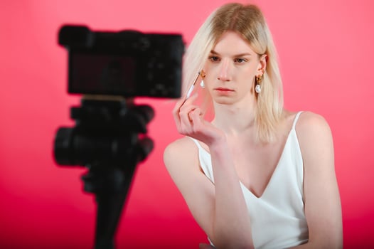 Young transgender woman on red background. photo