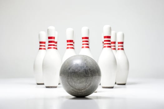 Bowling ball and pins on white background photo