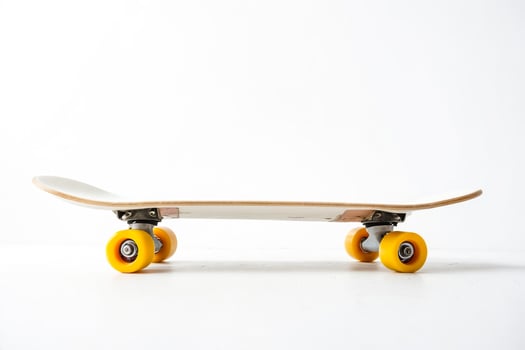 Skateboard with yellow wheels on white background photo
