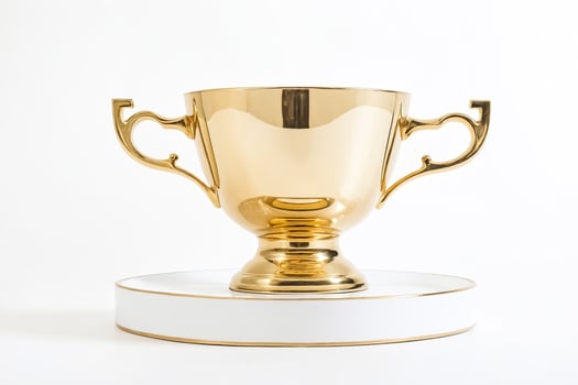 Golden trophy cup on white platform photo